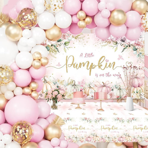 Pink and gold balloon garland arch over a baby shower backdrop with pumpkins and floral accents, featuring a tablecloth with matching design.