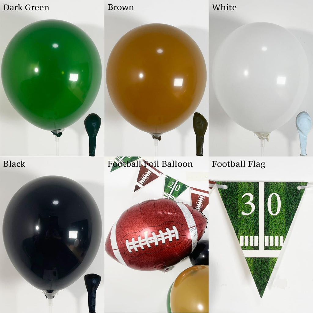 Collection of football-themed party balloons and decorations including dark green, brown, white, and black balloons, a football foil balloon, and a football field pennant banner.