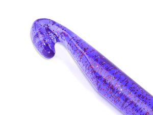 Close-up of a large purple crochet hook with red glitter flecks, showing the ergonomic handle and hook tip.