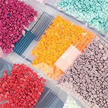 Diamond painting kit with bags of colorful round drills in red, orange, purple, gray, and teal.