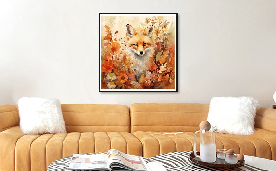 Framed 5D diamond painting kit featuring a fox surrounded by fall leaves and flowers, displayed on a wall above a sofa.