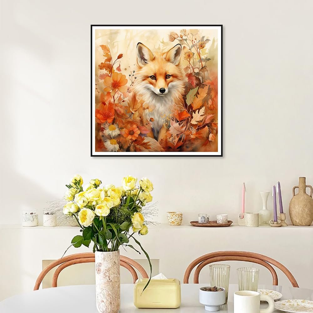 Diamond painting kit featuring a fox surrounded by fall leaves and flowers, framed on a wall.