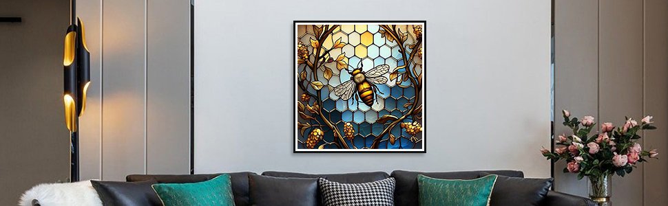 Diamond painting kit featuring a stained glass bee on a honeycomb background, framed and hanging on a wall above a sofa.