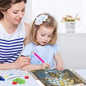Mother and daughter doing a diamond painting kit with a stained glass bee design