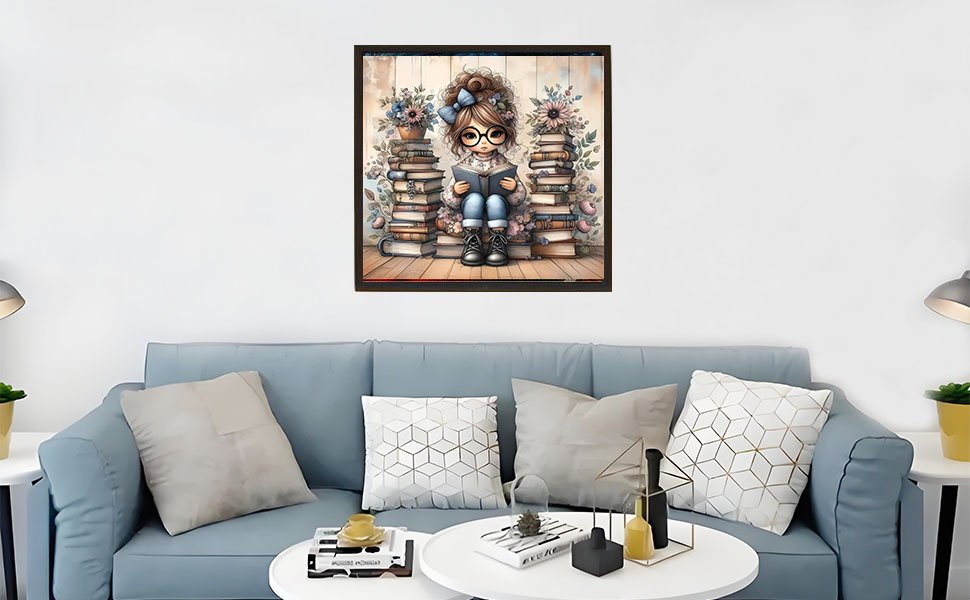 Diamond painting of a girl reading a book surrounded by stacks of books and flowers, framed and hanging above a sofa.