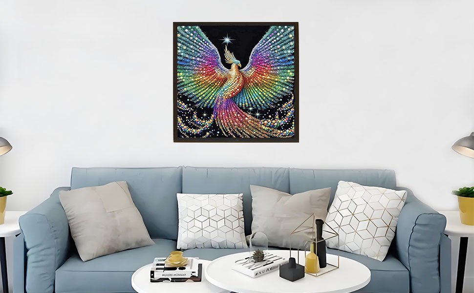 Framed 5D diamond painting of a colorful phoenix with outstretched wings hanging above a blue sofa.