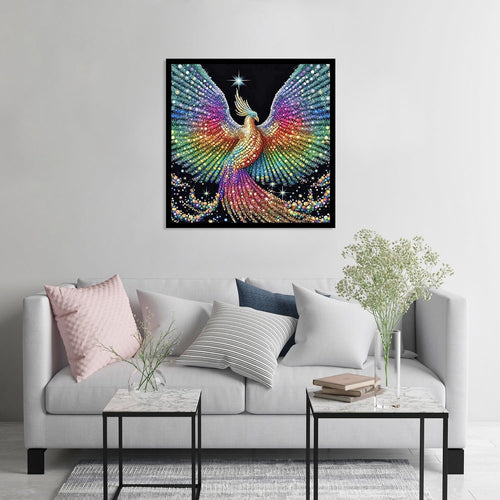 Diamond painting of a colorful phoenix with outstretched wings hanging on a wall above a sofa.
