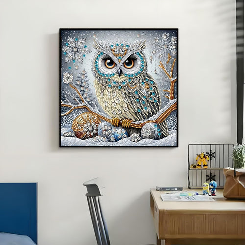 Diamond art painting of a detailed owl perched on a snowy branch with snowflakes and ornaments