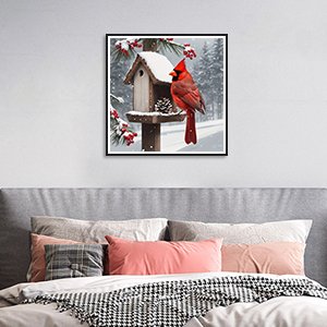 Framed 12x12 inch cardinal diamond painting kit displayed on a wall above a bed.