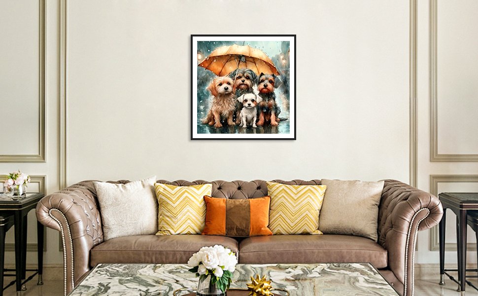 Framed diamond painting of four dogs sitting under an umbrella in the rain, displayed above a sofa.