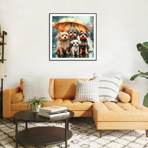 Framed dog diamond painting art of four dogs under an umbrella on a rainy street, displayed above a sofa.