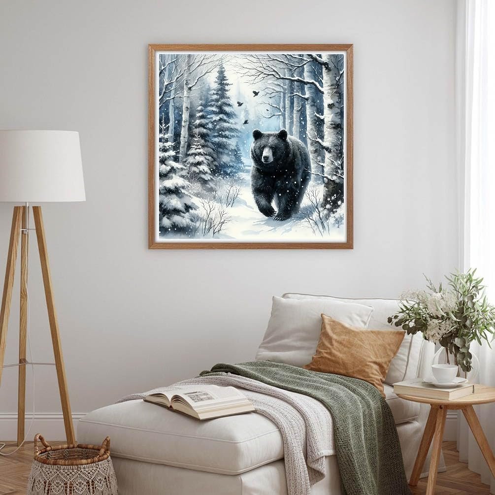 Framed diamond painting of a black bear walking through a snowy forest scene
