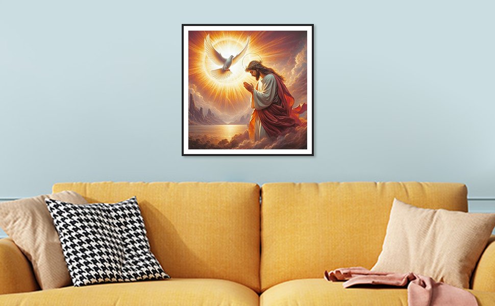 Framed diamond painting of Jesus praying with a dove flying above, displayed on a wall above a yellow couch.
