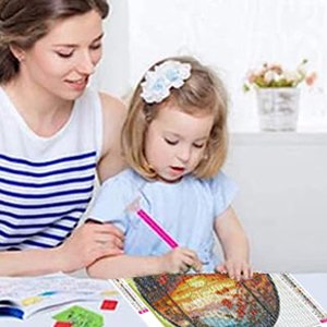 Mother and daughter doing a diamond painting kit together at a table, focusing on the canvas.