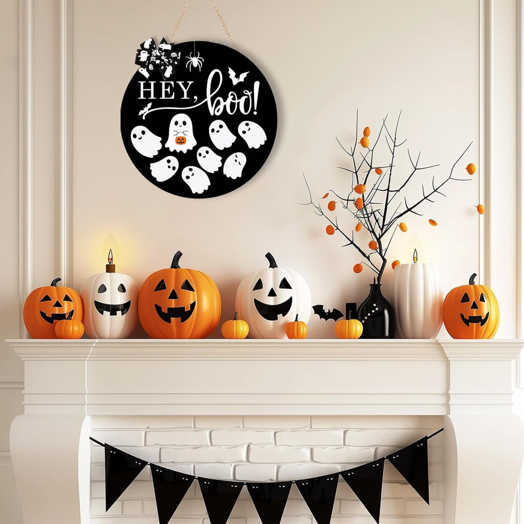 Round Halloween door sign with ghosts and 'Hey Boo!' text hanging above a fireplace decorated with pumpkins.