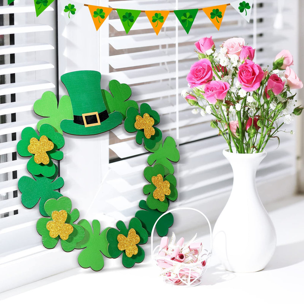 St. Patrick's Day wreath with shamrocks and a leprechaun hat, next to a vase of pink roses and a basket of pink ribbons.