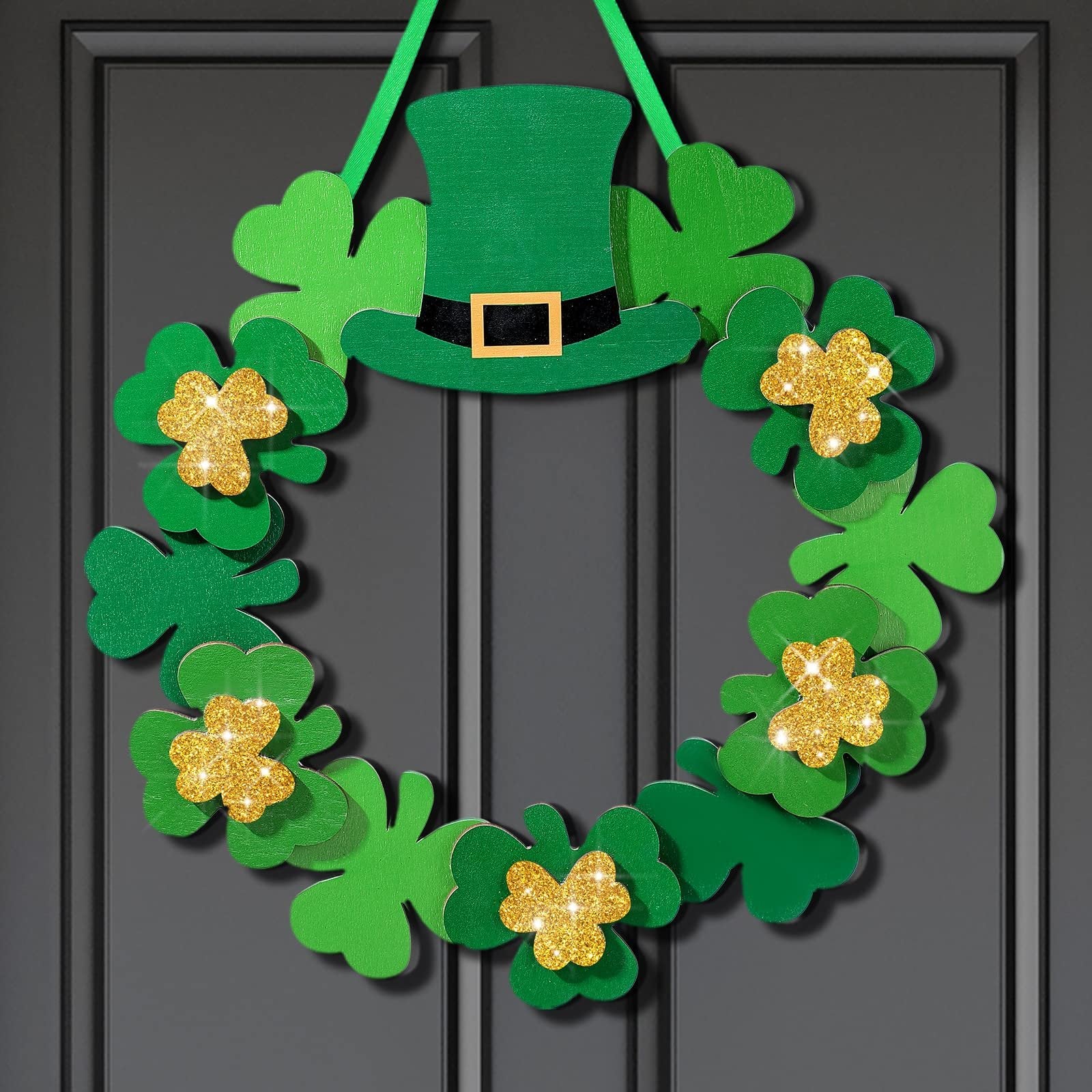Green St. Patrick's Day wreath with shamrocks and a leprechaun hat hanging on a dark door