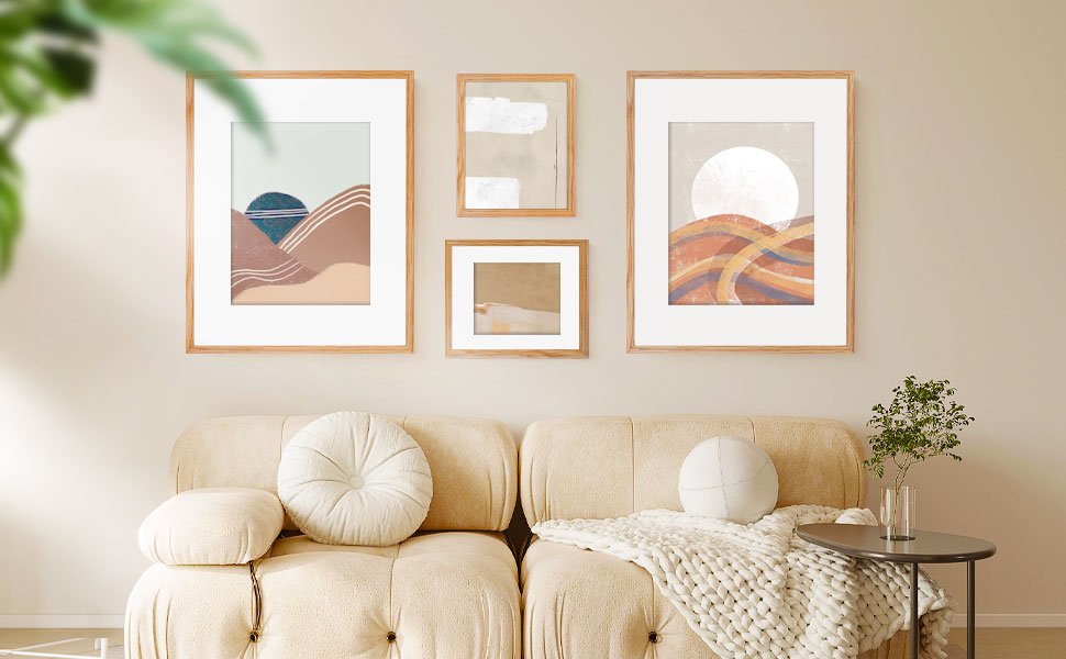 Four framed abstract art prints displayed above a sofa in a living room setting.