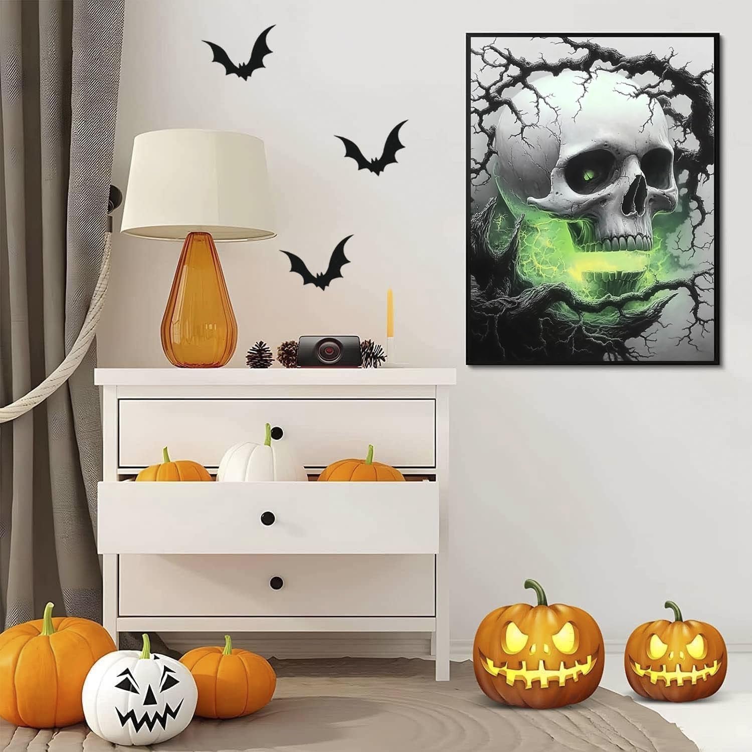 Halloween-themed room decor with a diamond art painting of a skull emitting green light, pumpkins, and bat wall decals.
