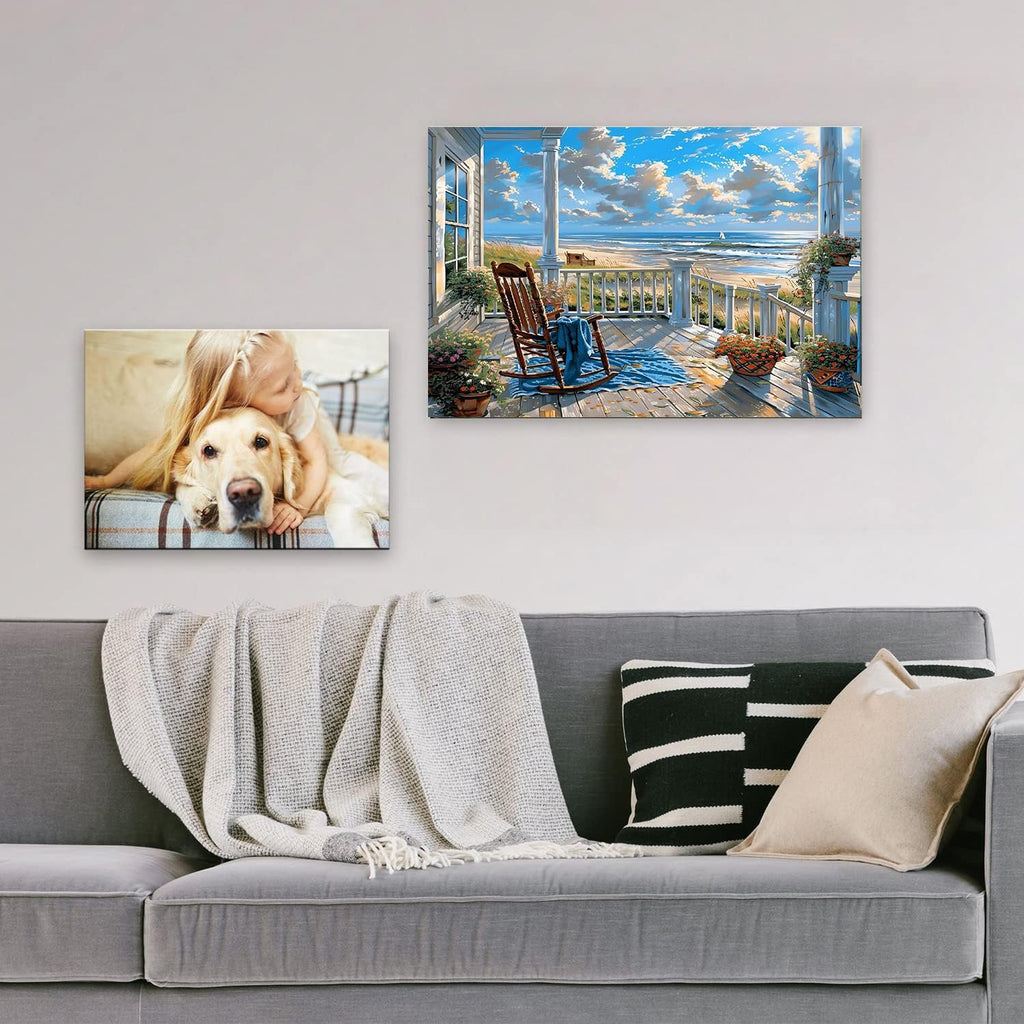 Two framed diamond art paintings displayed on a wall above a sofa: one of a girl hugging a golden retriever, the other of a beach scene from a porch.