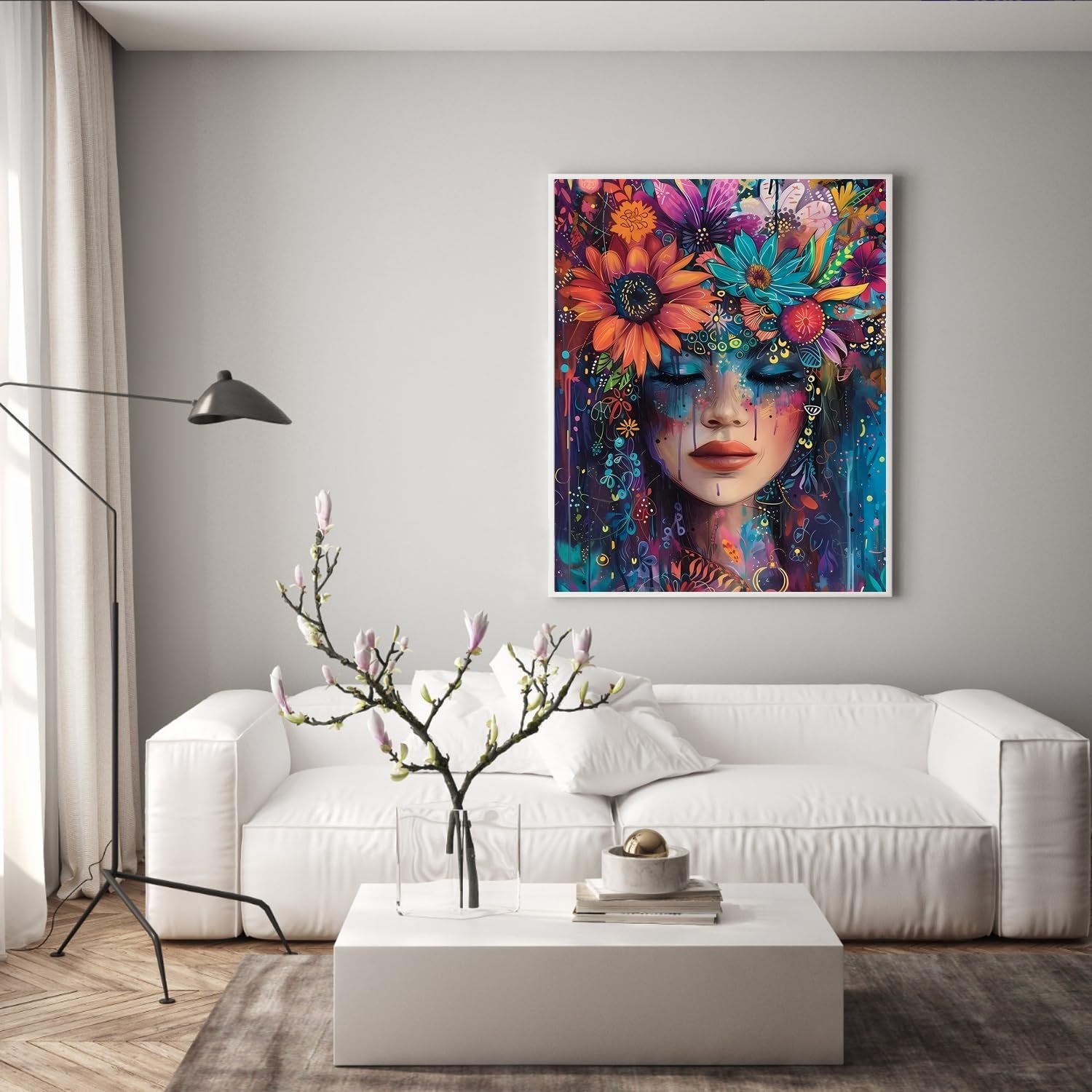 Framed abstract floral portrait art hanging above a white sofa in a living room setting