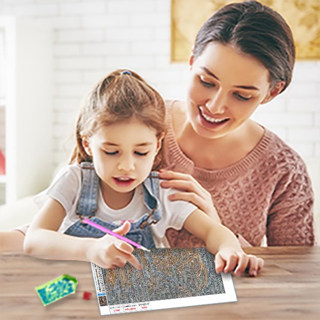 Woman and child doing diamond painting kit at a table, close-up view.