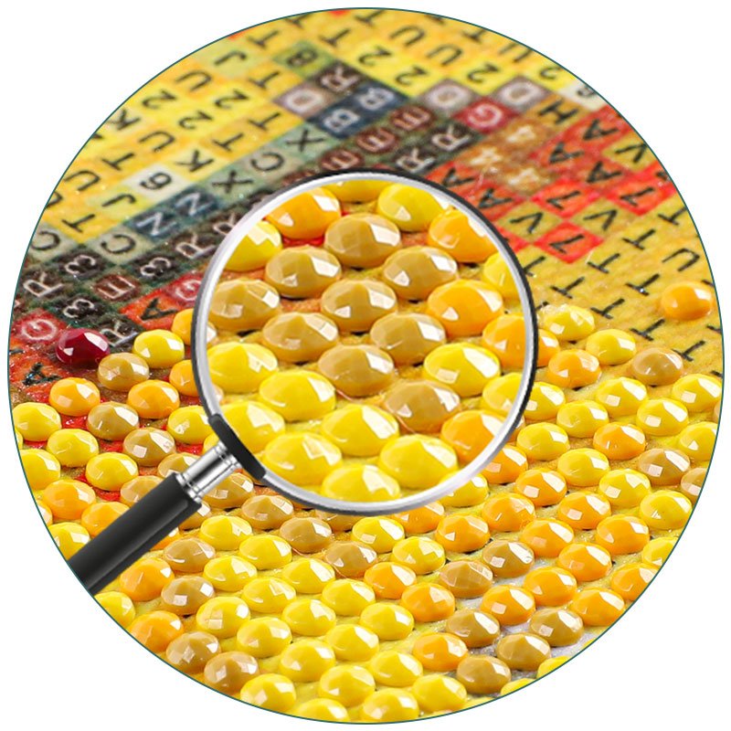 Close-up of a diamond painting kit showing colorful resin diamonds and lettered grid under a magnifying glass.