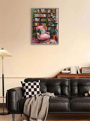Diamond painting of a cozy reading nook with a pink armchair, bookshelves, and plants.