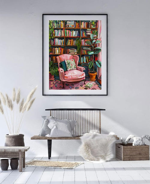 Framed diamond painting of a pink armchair in a room with bookshelves and plants.