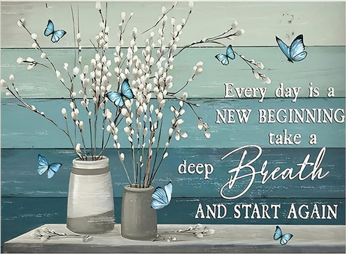 Two vases with white pussy willow branches and blue butterflies against a teal and light blue wood plank background.