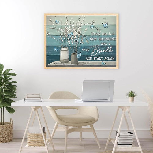 Framed diamond painting of white pussy willow branches in vases with blue butterflies and inspirational quote on a desk.