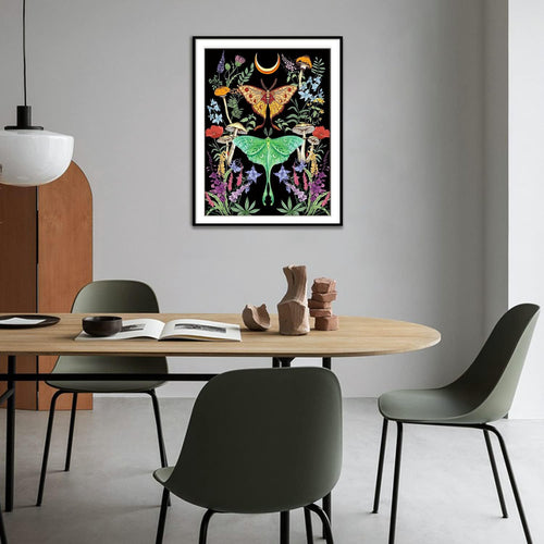 Diamond art kit with luna moth, butterfly, moon, mushrooms, and flowers on black background, framed and hanging on a wall.