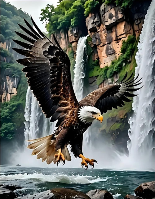 Bald eagle in flight over choppy water with waterfalls and lush green cliffs in the background.