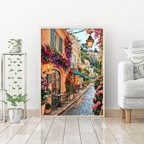Diamond painting kit of a charming European street lined with flowers and cafes, showing a cobblestone path and buildings.