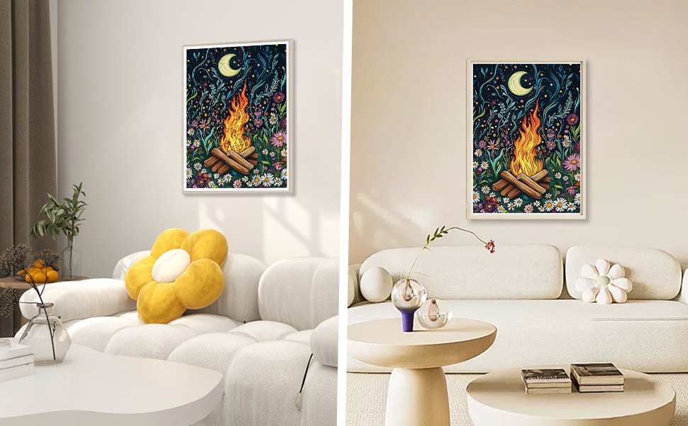 Diamond painting of a campfire at night with a moon and flowers, framed and hanging on a wall above a sofa.