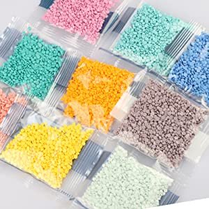 Diamond painting kit with multiple small plastic bags filled with colorful round drill beads for crafting.