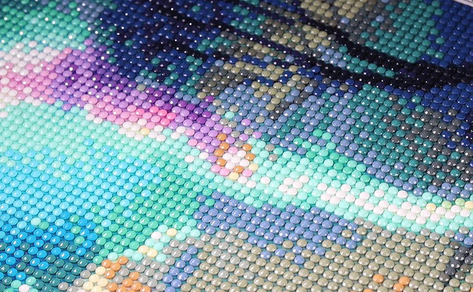 Close-up of a diamond painting kit showing a colorful butterfly design with round gems in shades of blue, purple, pink, and green.