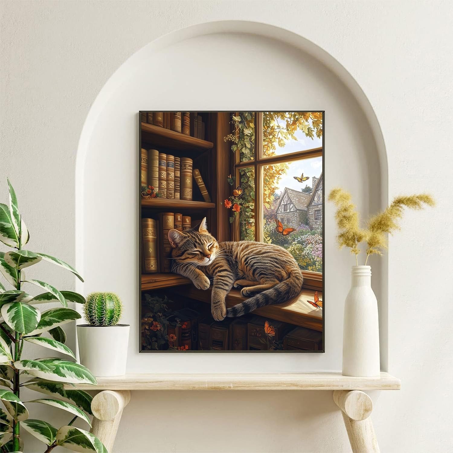 Cat sleeping on a windowsill with bookshelves and a village scene outside the window.