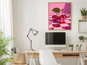 Framed diamond painting kit artwork of two shiny cherries on a pink checkered floor, displayed in a home office setting.