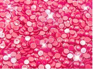 Close-up of pink diamond painting beads with sparkling light effects, filling the frame.