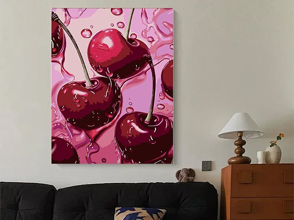 Close-up of a diamond painting kit featuring glossy red cherries with water droplets on a pink background.