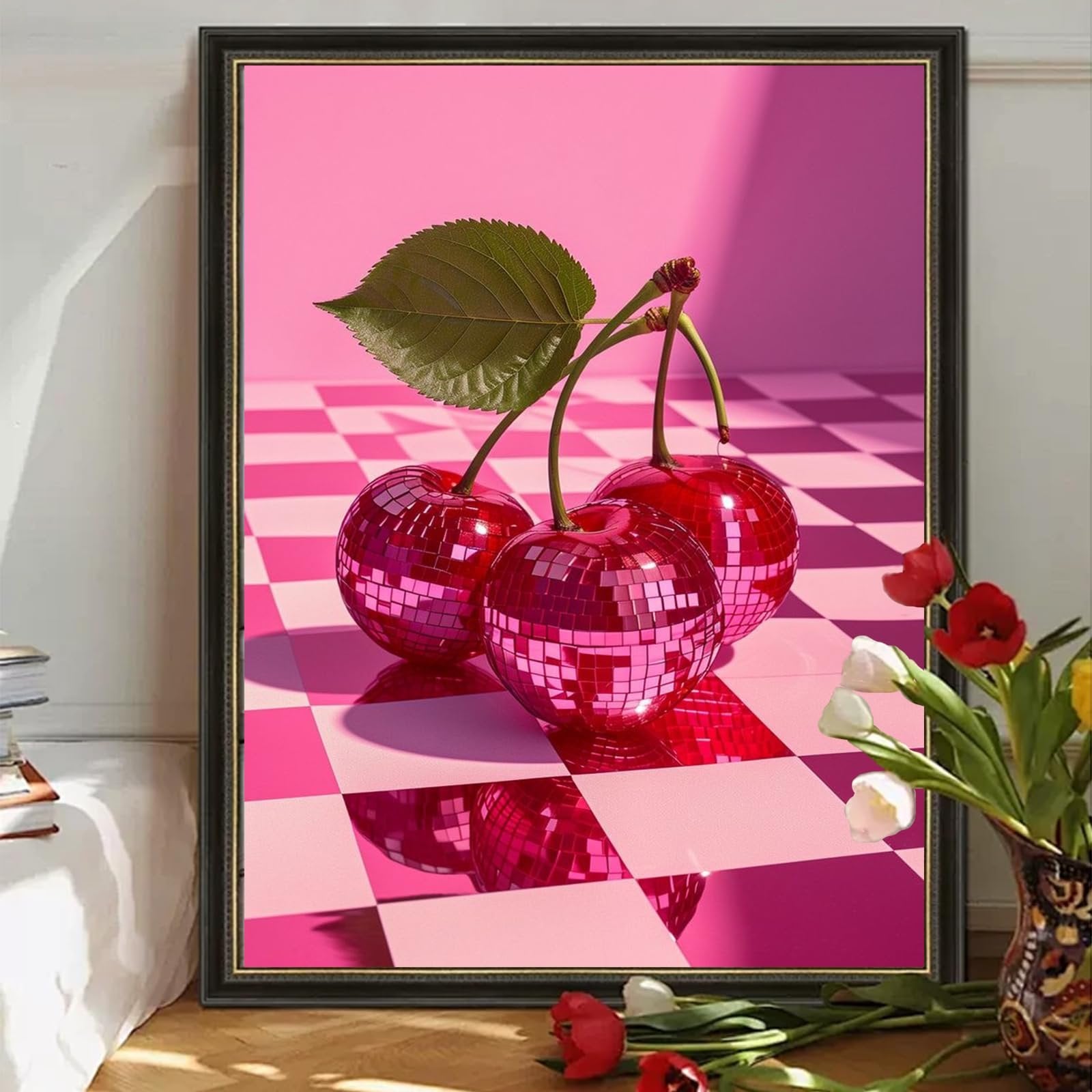Three disco ball cherries with a leaf on a pink checkered floor, framed.