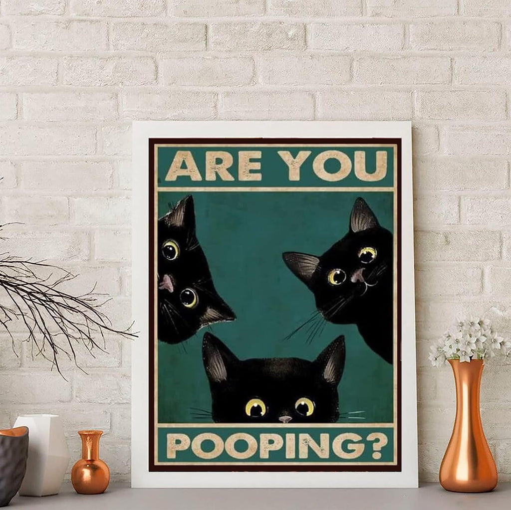 Three black cats peeking over a teal background with text that reads "ARE YOU POOPING?"