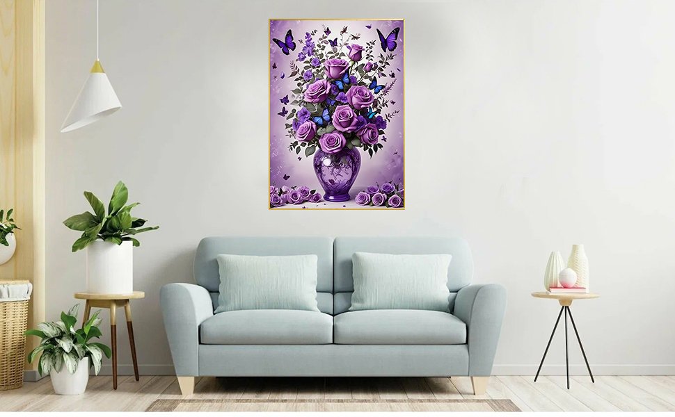 Diamond art painting of purple roses and butterflies in a vase, displayed on a wall above a sofa.