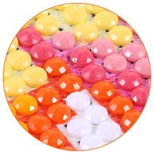 Close-up of colorful diamond painting beads in yellow, pink, and orange arranged on a canvas with a soaring eagle pattern.