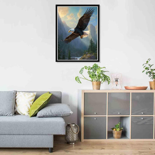 Soaring eagle over a mountain landscape with a river and pine trees, framed artwork.