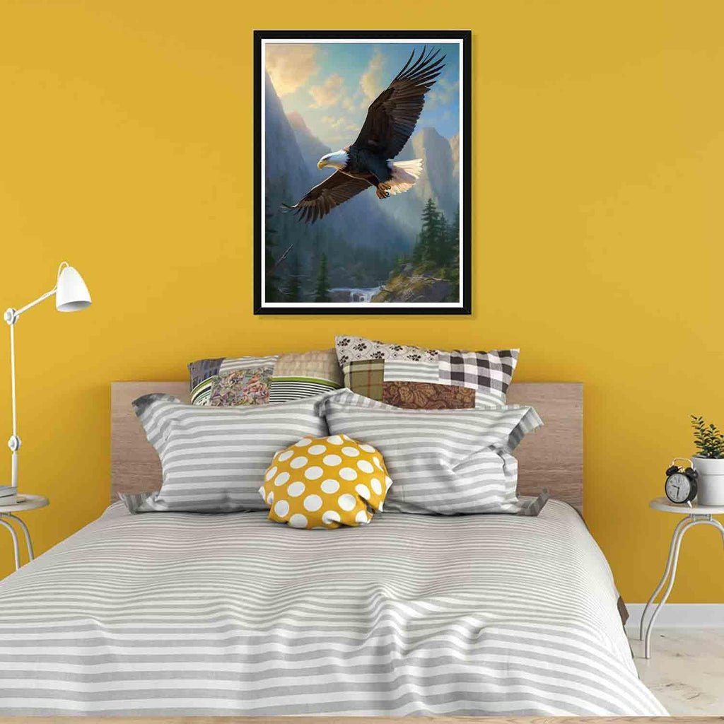 Framed 5D diamond art kit featuring a soaring eagle over a mountain landscape, displayed on a yellow wall above a bed.