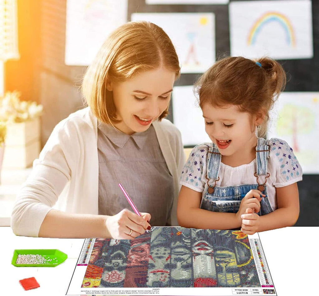 Mother and daughter doing a Halloween-themed kit together at a table.