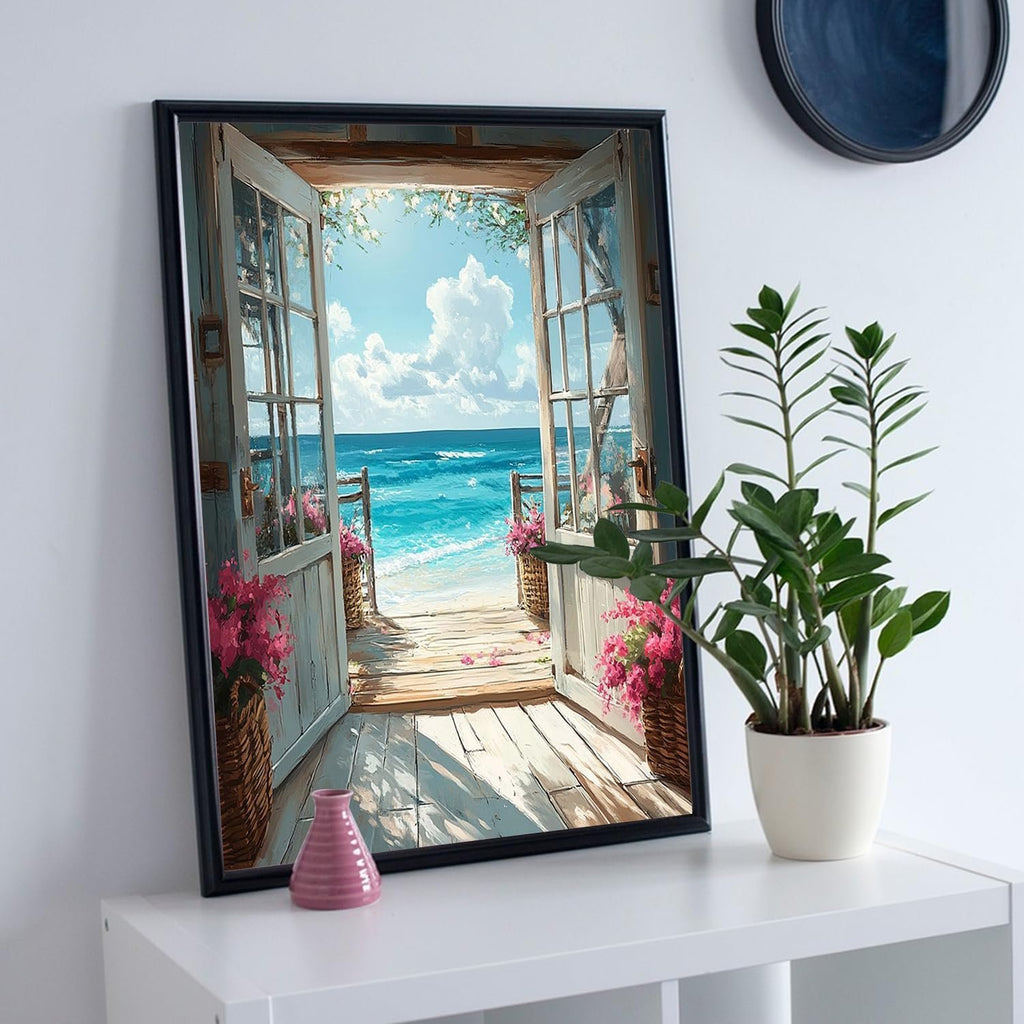 Framed artwork of an open doorway leading to a beach scene with blue ocean and sky.