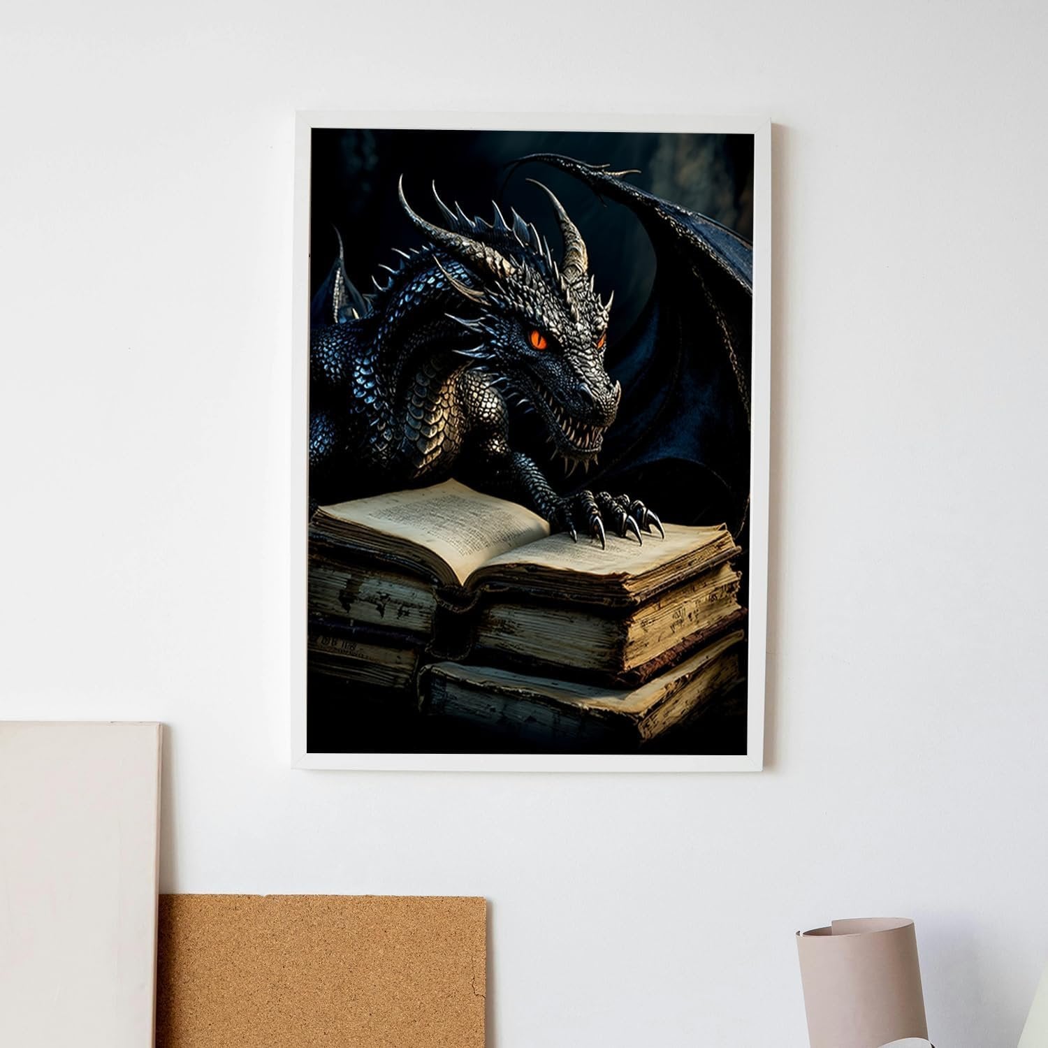 Black dragon with glowing orange eyes resting on a stack of old books, framed artwork